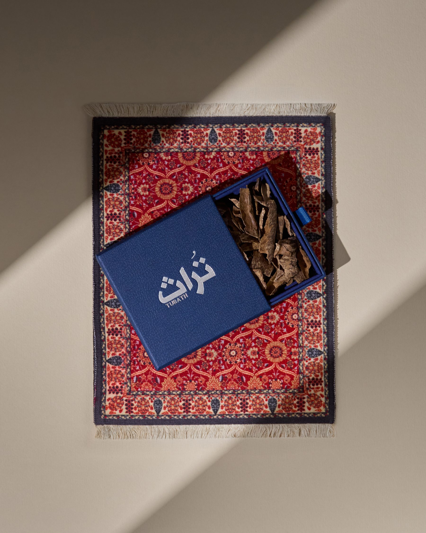 Turath premium oud gift box on a traditional rug